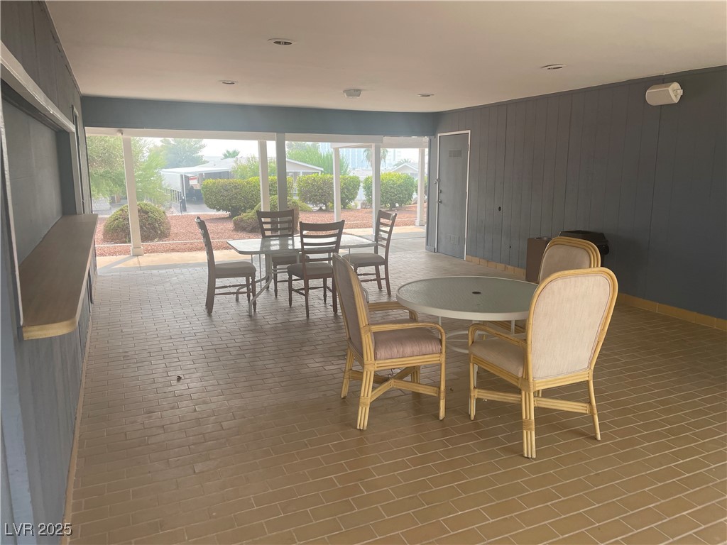 4641 Royal Ridge Boulevard Las Vegas, NV 89103 - Photo 35 of 38 Dining area with wood walls and baseboards