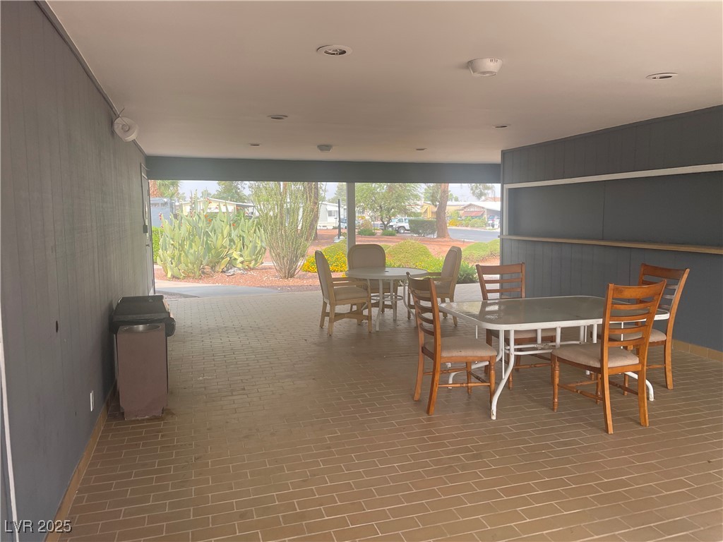 4641 Royal Ridge Boulevard Las Vegas, NV 89103 - Photo 36 of 38 Dining room featuring wooden walls and brick patterned flooring