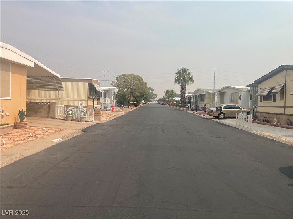 4641 Royal Ridge Boulevard Las Vegas, NV 89103 - Photo 4 of 38 View of asphalt street with a residential view, sidewalks, and curbs