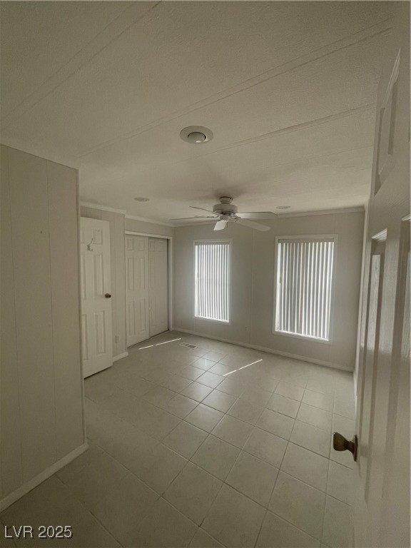 4641 Royal Ridge Boulevard Las Vegas, NV 89103 - Photo 9 of 38 Unfurnished room with tile patterned floors, ceiling fan, and a textured ceiling