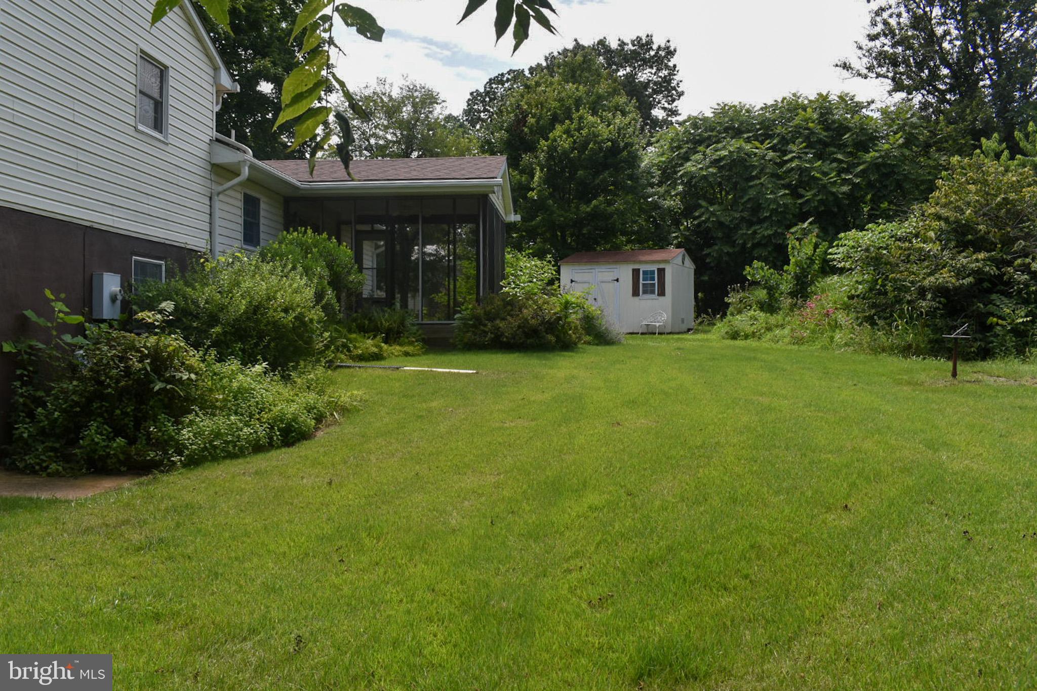 15650 Gibson Mill Road Culpeper, VA 22701 - Photo 26 of 28 Lush backyard oasis with vibrant greenery.