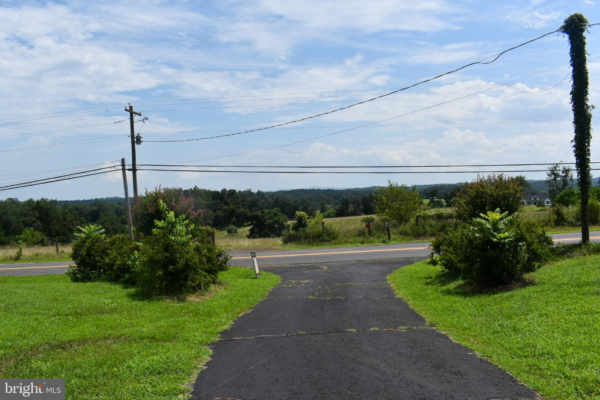 15650 Gibson Mill Road Culpeper, VA 22701 - Photo 4 of 28 Scenic drive through lush greenery ahead.