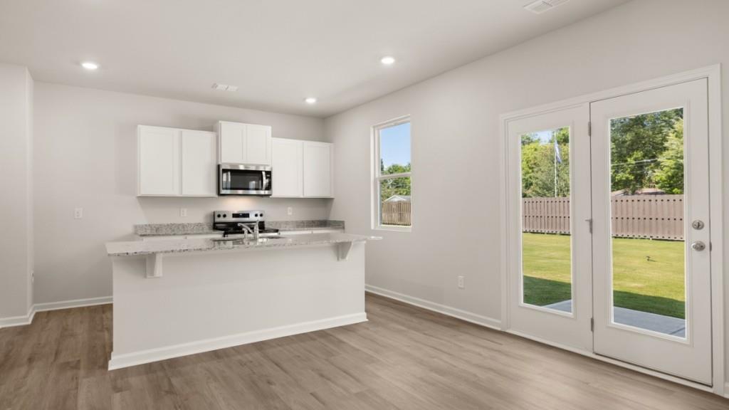 111 Babcock Drive Northeast Rome, GA 30165 - Photo 5 of 33 a kitchen with stainless steel appliances granite countertop a stove top oven and a sink with granite countertops