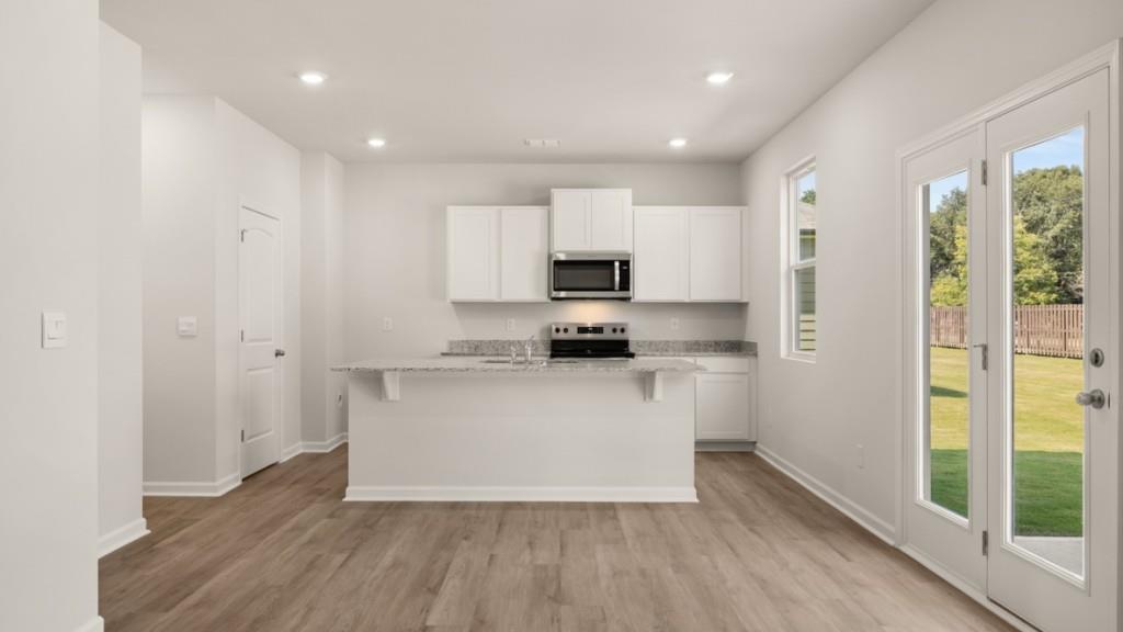 111 Babcock Drive Northeast Rome, GA 30165 - Photo 6 of 33 a kitchen with wooden floors and white appliances