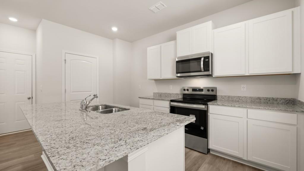 111 Babcock Drive Northeast Rome, GA 30165 - Photo 7 of 33 a kitchen with stainless steel appliances granite countertop a stove a sink and a microwave