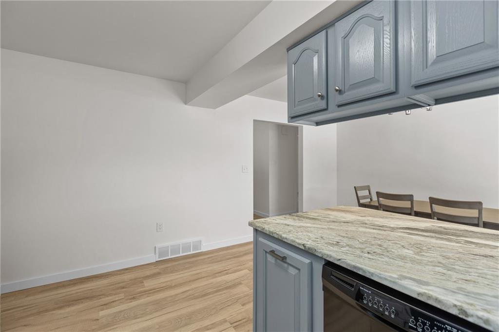 952 Achortown Road Beaver Falls, PA 15010 - Photo 11 of 43 a kitchen with granite countertop cabinets and wooden floor