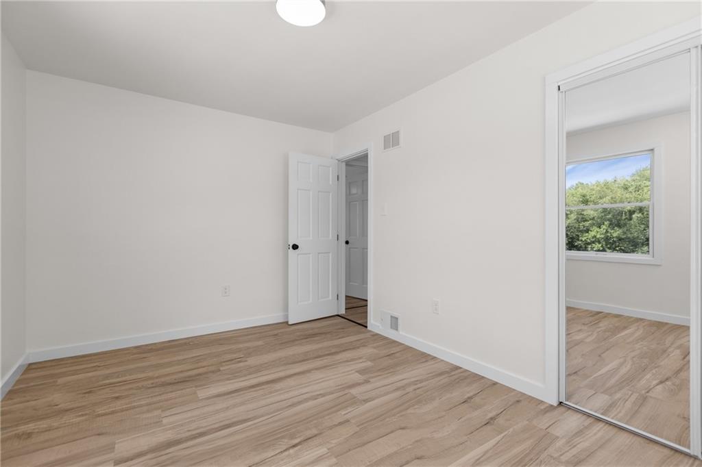 952 Achortown Road Beaver Falls, PA 15010 - Photo 19 of 43 a view of an empty room with wooden floor and a window