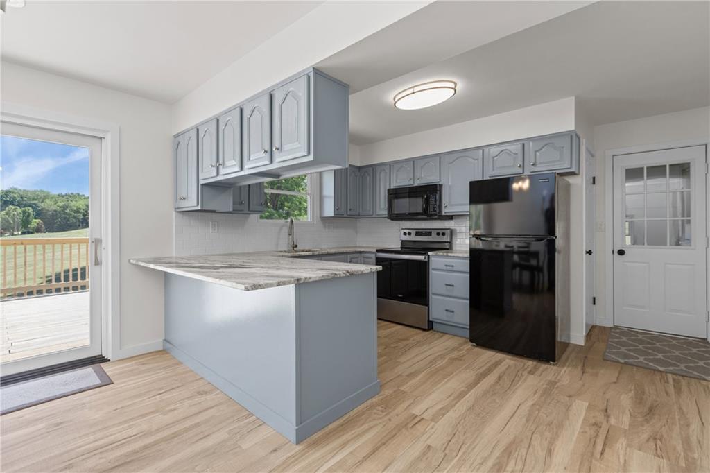 952 Achortown Road Beaver Falls, PA 15010 - Photo 5 of 43 a kitchen with stainless steel appliances granite countertop a refrigerator and a stove top oven