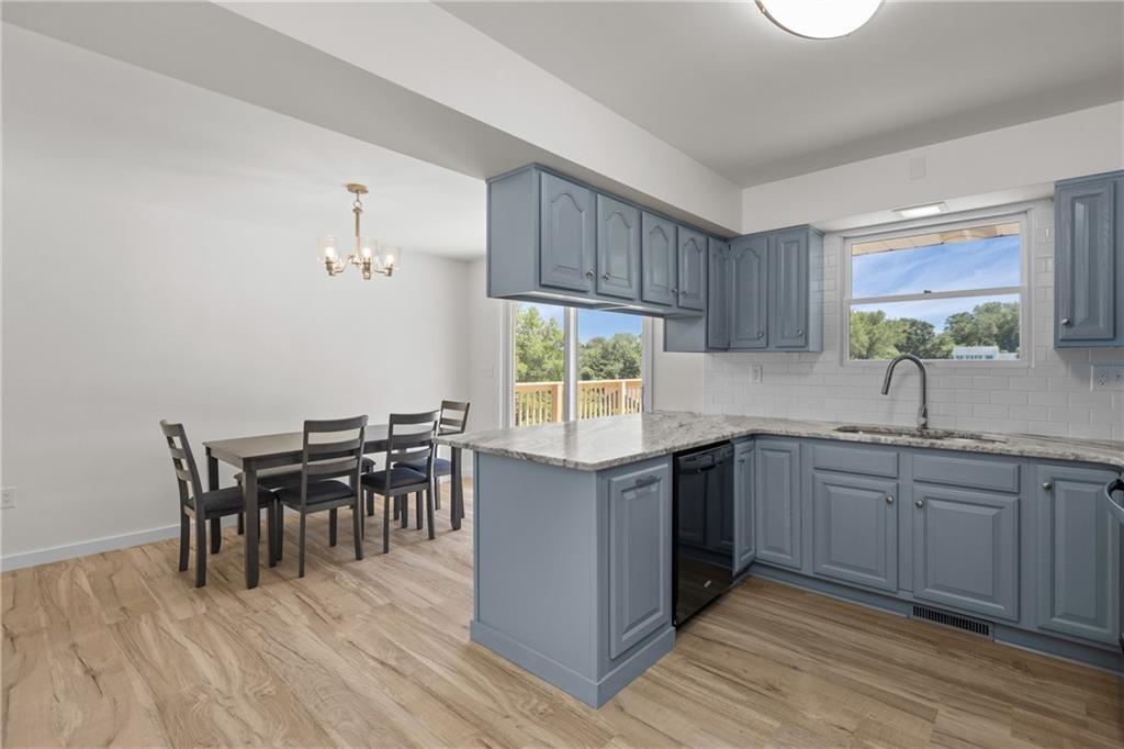 952 Achortown Road Beaver Falls, PA 15010 - Photo 10 of 43 a kitchen with granite countertop a sink dining table and chairs