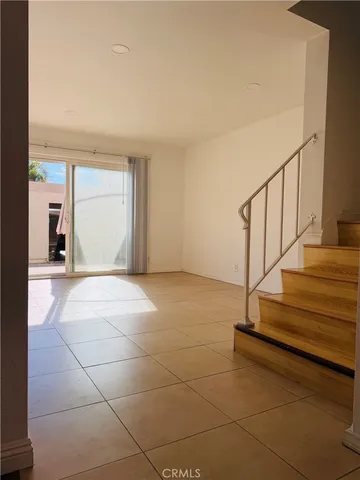 a view of an empty room with closet and a window
