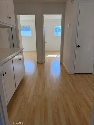 a view of a room with wooden floor
