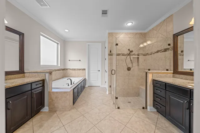 a bathroom with a granite countertop sink a toilet a mirror and shower