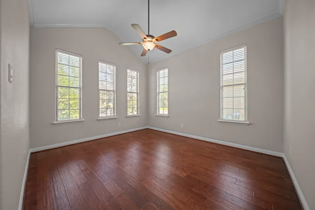 a view of a livingroom with a window and wooden floor