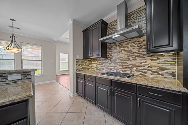 a kitchen with stainless steel appliances granite countertop a sink stove and cabinets