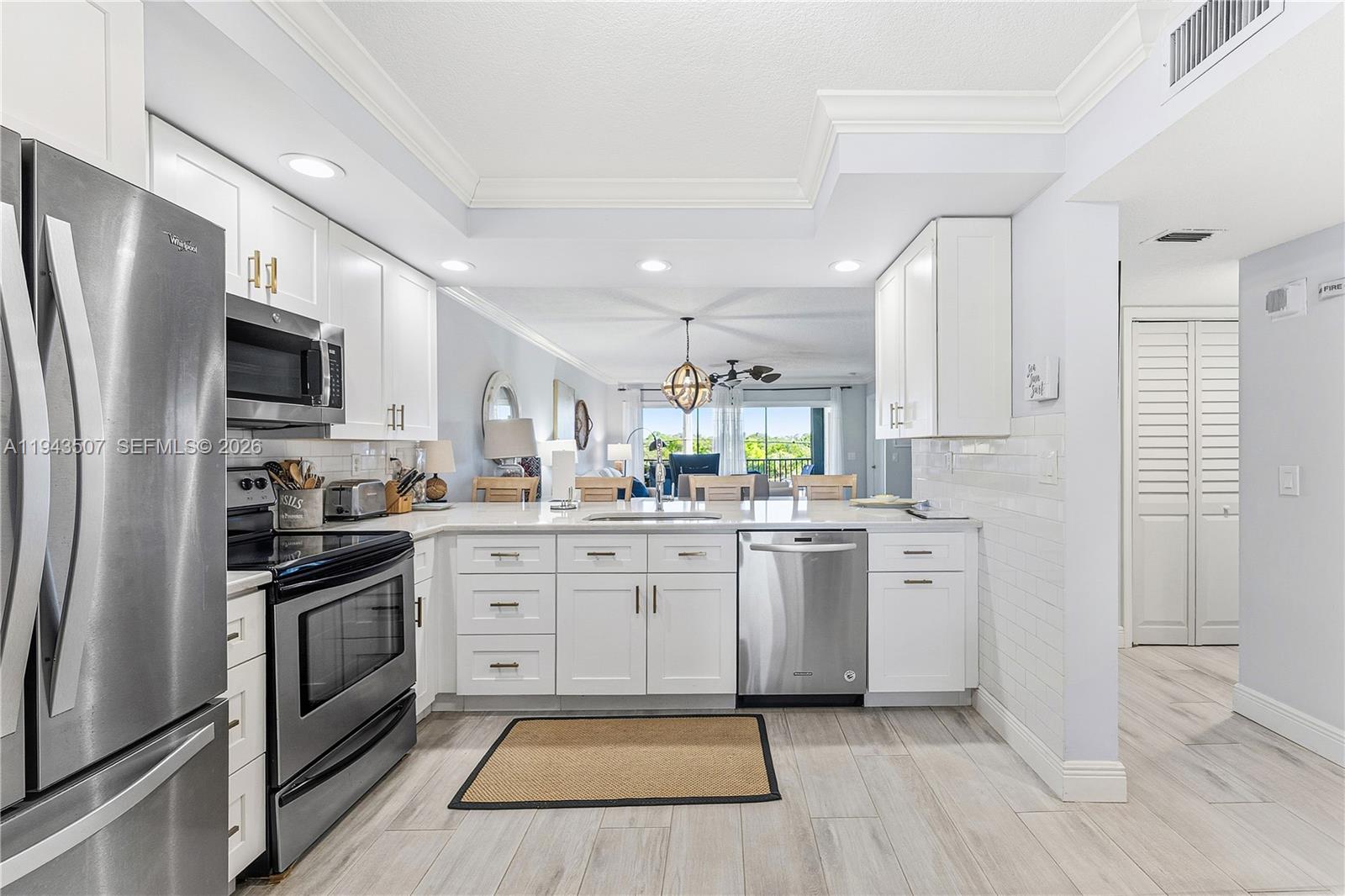 a kitchen with white cabinets stainless steel appliances and sink