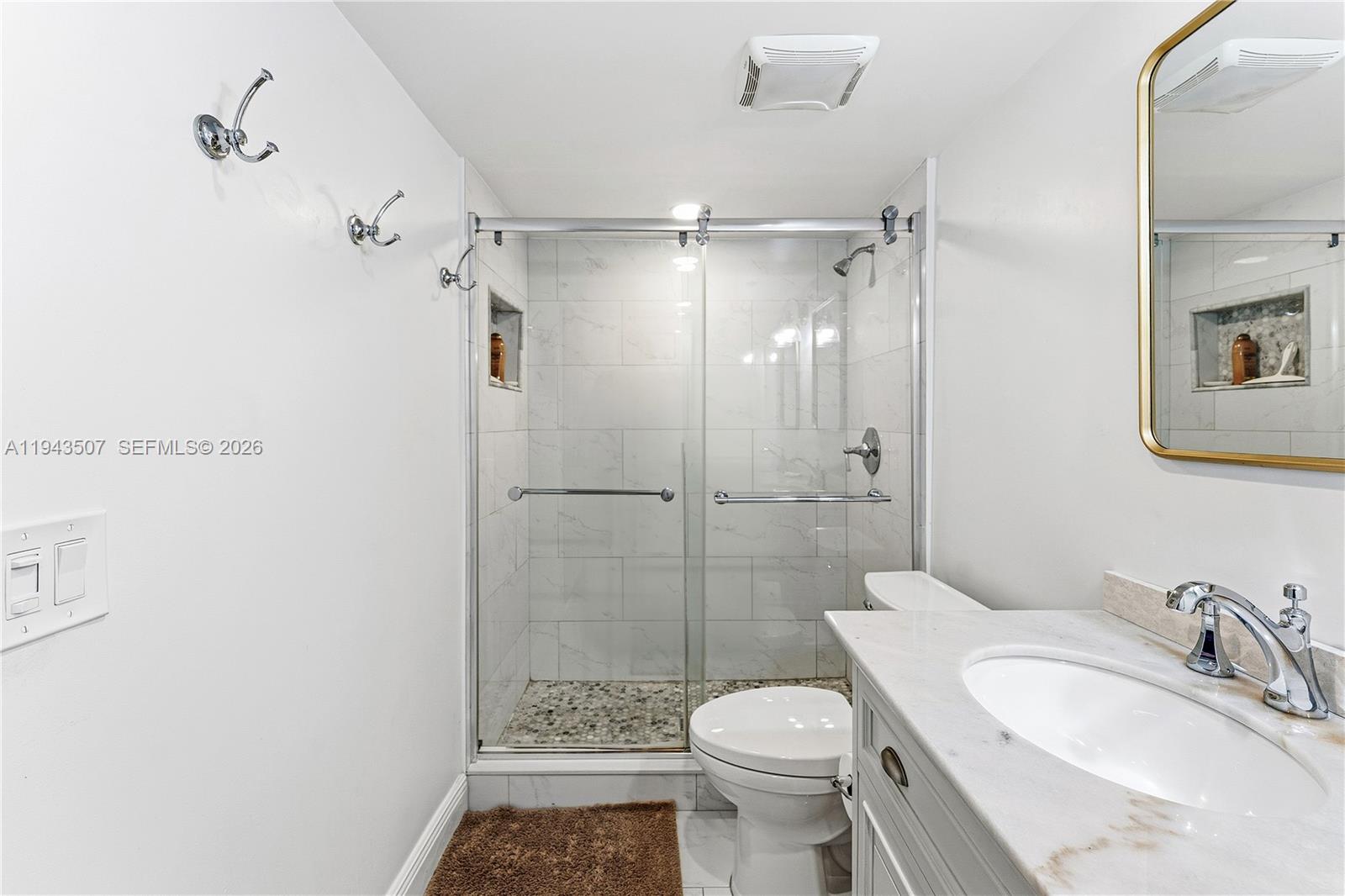 275 Palm Avenue, Unit B207 Jupiter, FL 33477 - Photo 13 of 29 a bathroom with a sink toilet and shower