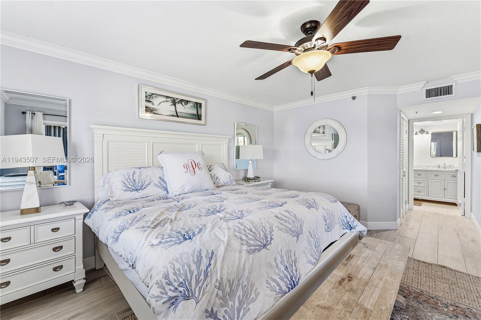 275 Palm Avenue, Unit B207 Jupiter, FL 33477 - Photo 15 of 29 a bedroom with a large bed and a chandelier