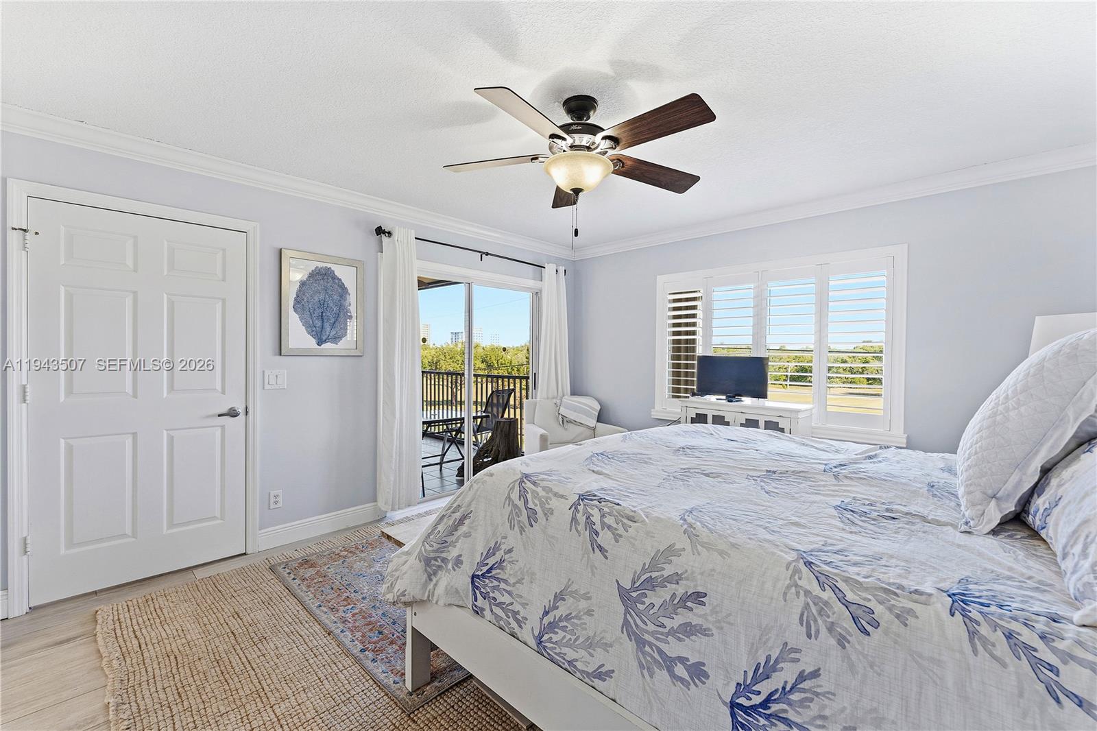 275 Palm Avenue, Unit B207 Jupiter, FL 33477 - Photo 16 of 29 a bedroom with a large bed and a window