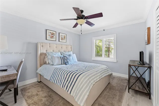 a bedroom with a bed a desk and chair