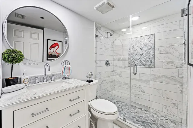 a bathroom with a toilet sink and shower