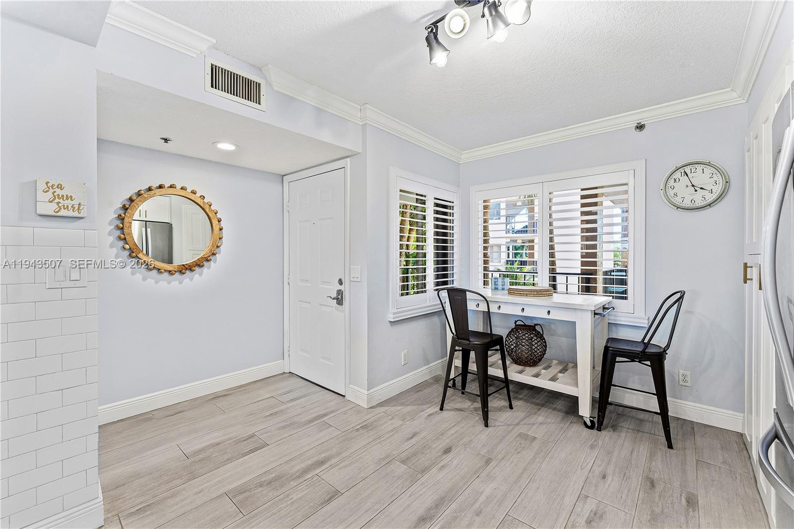 275 Palm Avenue, Unit B207 Jupiter, FL 33477 - Photo 3 of 29 a view of a dining room with furniture and a window