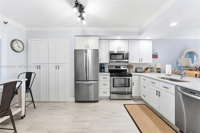 a kitchen with stainless steel appliances a refrigerator stove microwave and cabinets