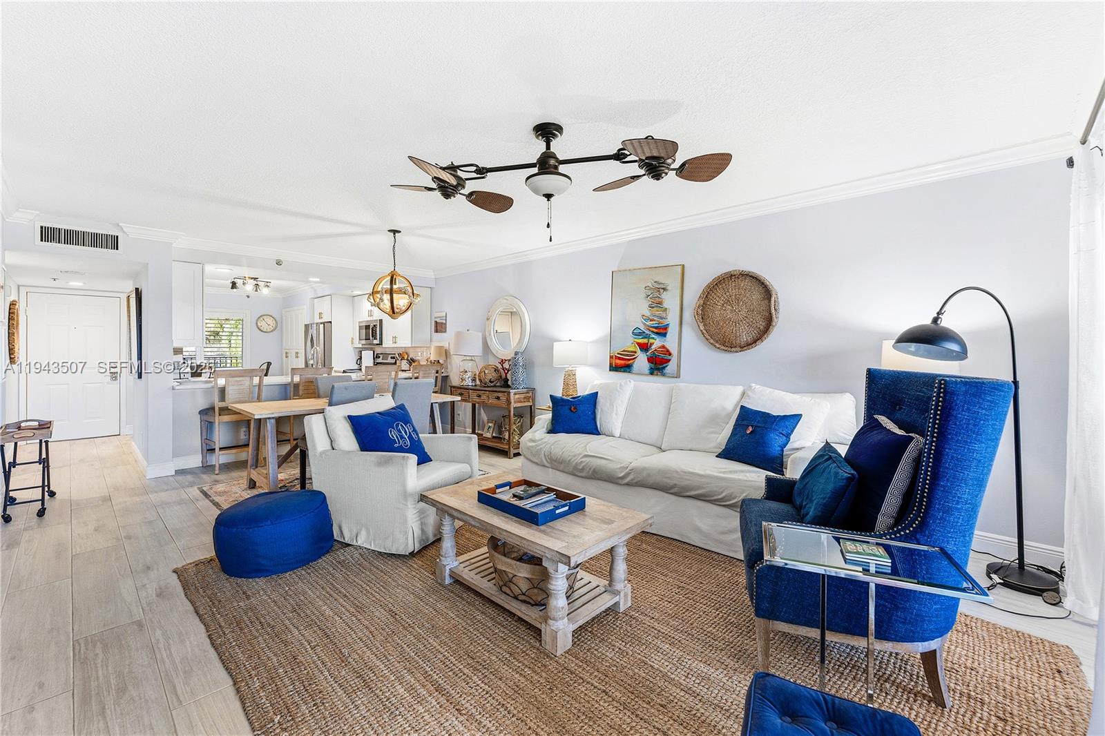 275 Palm Avenue, Unit B207 Jupiter, FL 33477 - Photo 9 of 29 a living room with lots of furniture and view of kitchen