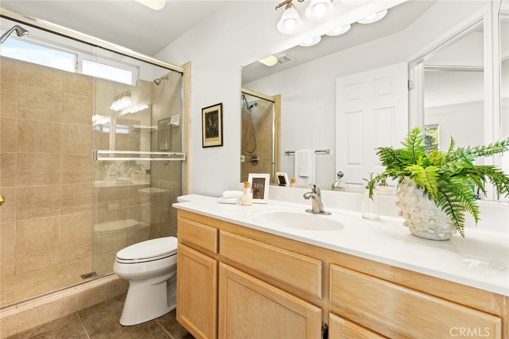 38 Lacewing Court Chico, CA 95973 - Photo 15 of 46 a bathroom with a sink a toilet a mirror and shower