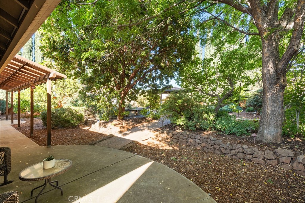 38 Lacewing Court Chico, CA 95973 - Photo 25 of 46 a backyard of a house with table and chairs under an umbrella