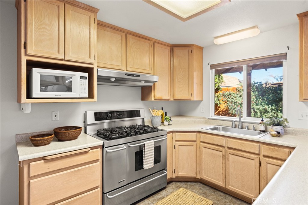 38 Lacewing Court Chico, CA 95973 - Photo 10 of 46 a kitchen with cabinets appliances a sink and a window