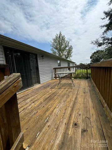 a view of balcony with wooden floor and fence