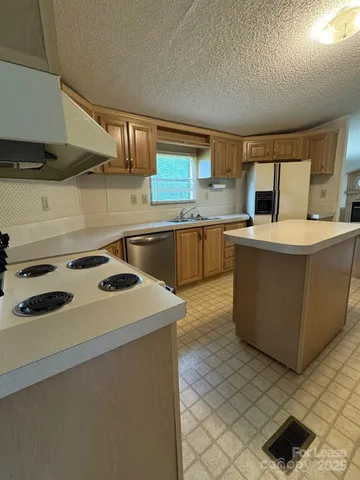 a kitchen with a stove and a sink