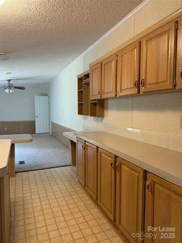 a kitchen with stainless steel appliances granite countertop a granite counter tops and a view of living room