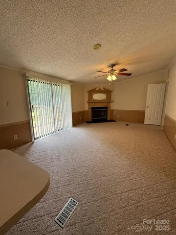 a view of an empty room with a fireplace