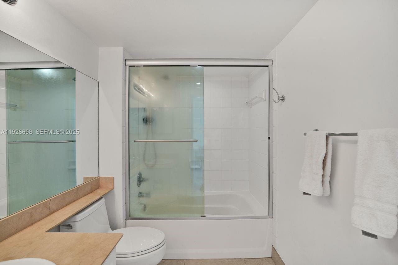 90 Alton Road, Unit 2907 Miami Beach, FL 33139 - Photo 19 of 42 a bathroom with a shower and a toilet