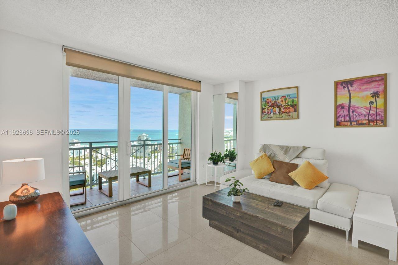 90 Alton Road, Unit 2907 Miami Beach, FL 33139 - Photo 2 of 42 a living room with furniture and a large window