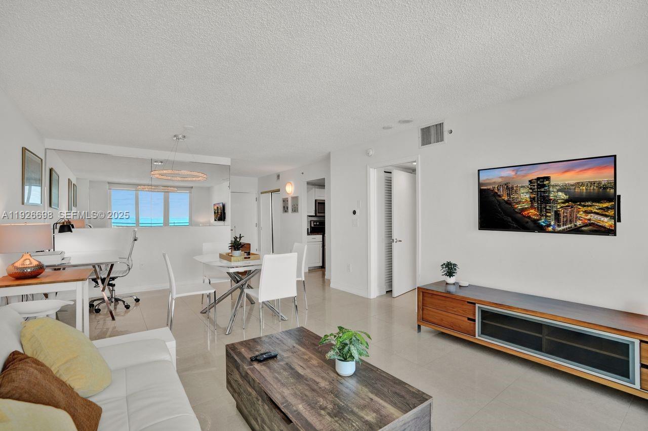90 Alton Road, Unit 2907 Miami Beach, FL 33139 - Photo 21 of 42 a living room with furniture and a flat screen tv