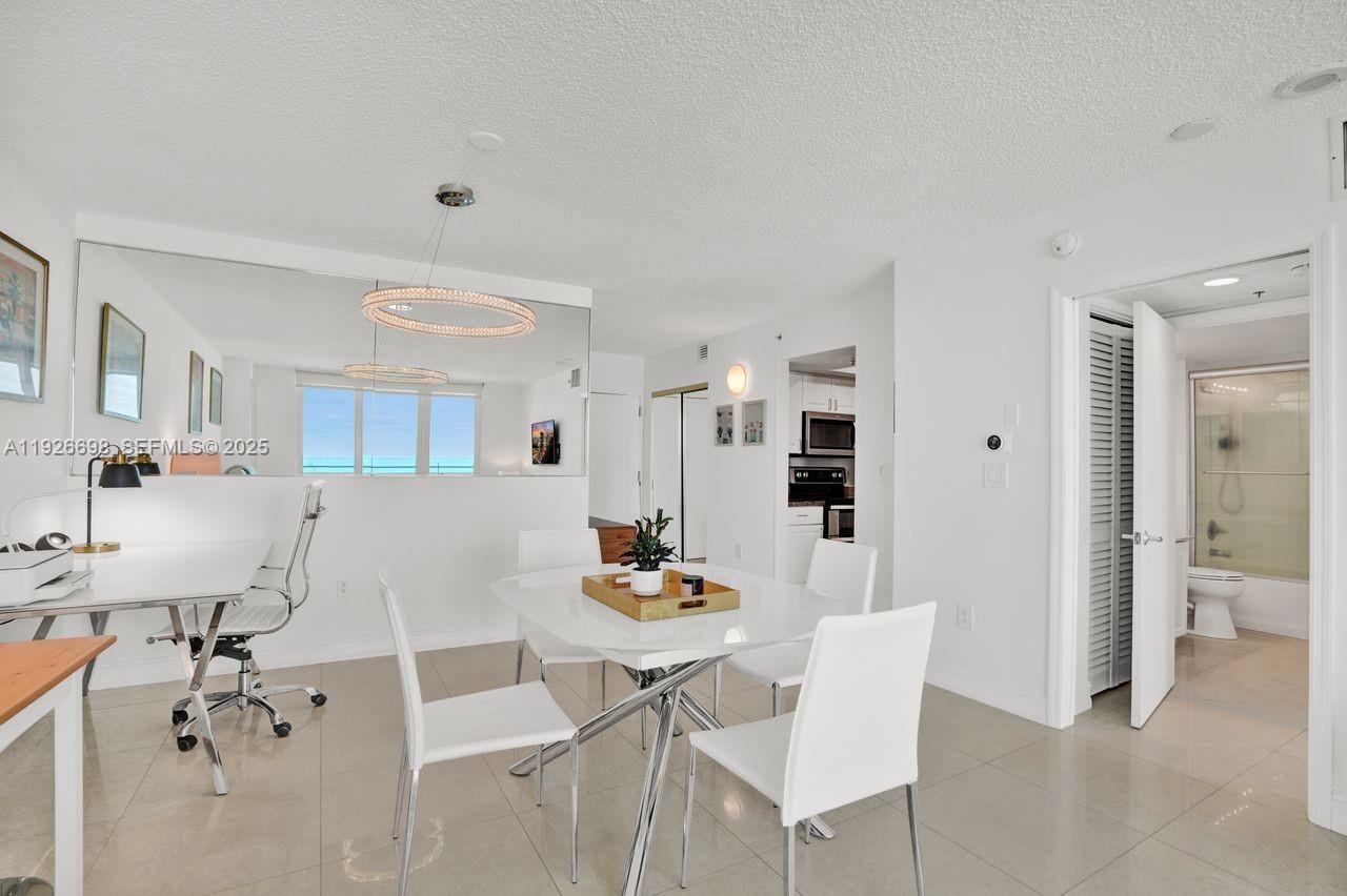 90 Alton Road, Unit 2907 Miami Beach, FL 33139 - Photo 27 of 42 a dining room with furniture and a view of kitchen