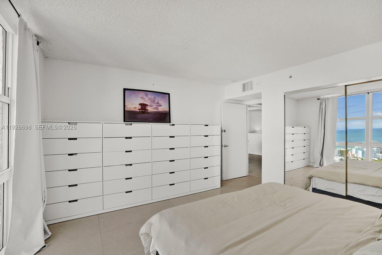 90 Alton Road, Unit 2907 Miami Beach, FL 33139 - Photo 29 of 42 a bedroom with a bed and closet