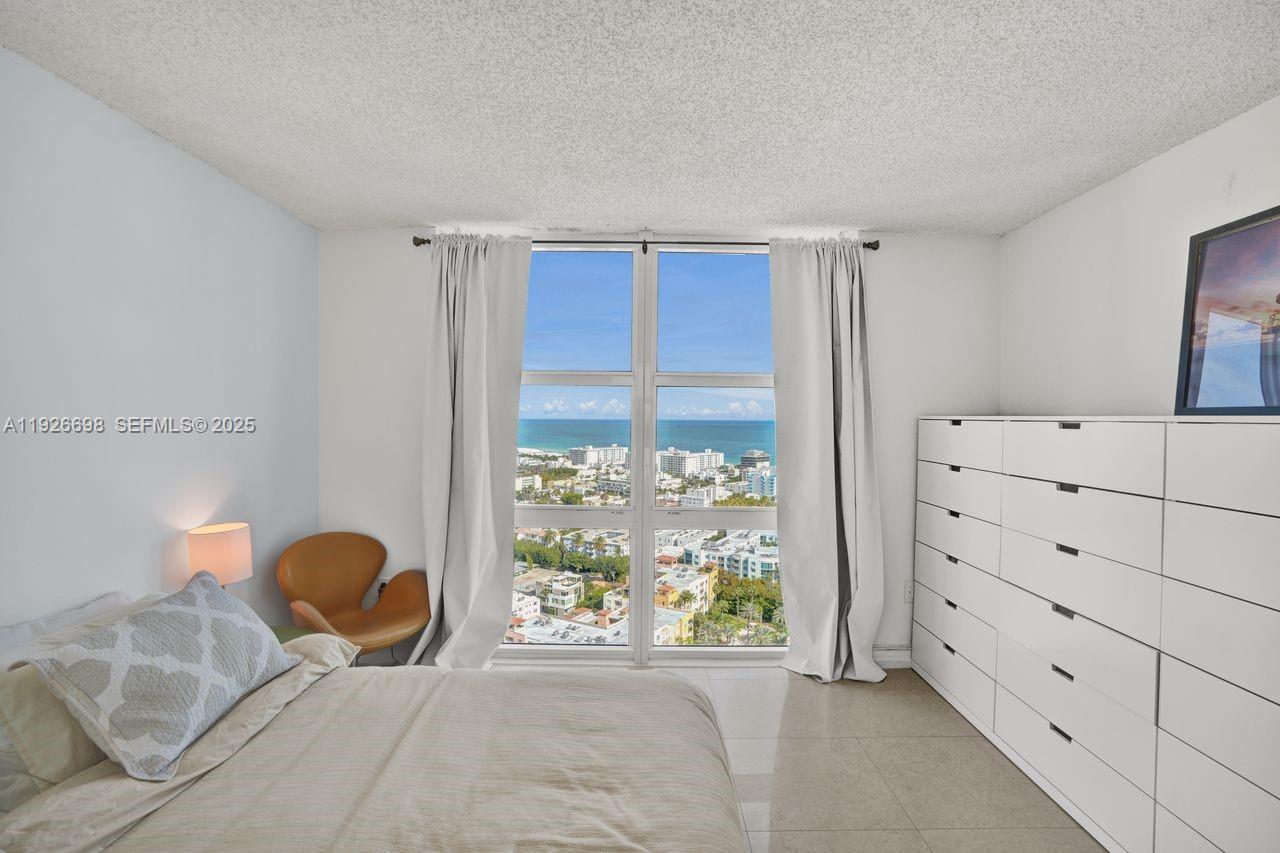 90 Alton Road, Unit 2907 Miami Beach, FL 33139 - Photo 7 of 42 a bedroom with a bed and a window