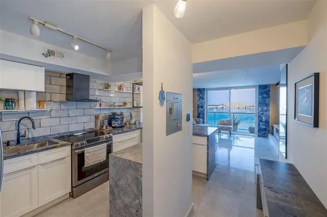 a kitchen with granite countertop a table and chairs in it