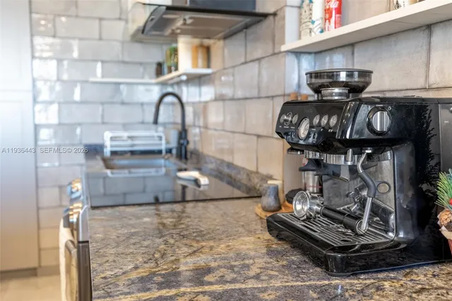 a view of a dining room with furniture a potted plant and wooden floor