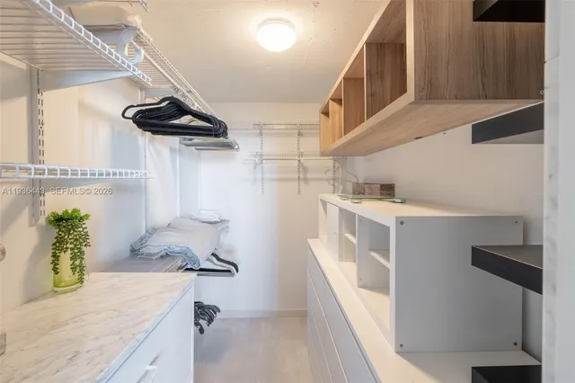 a kitchen with stainless steel appliances cabinets and a window