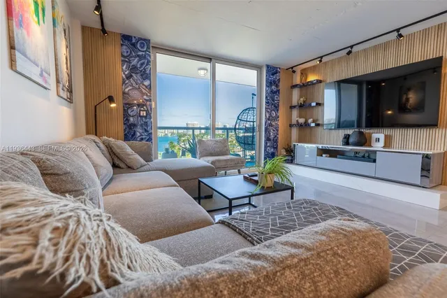 a living room with furniture and painting on the wall