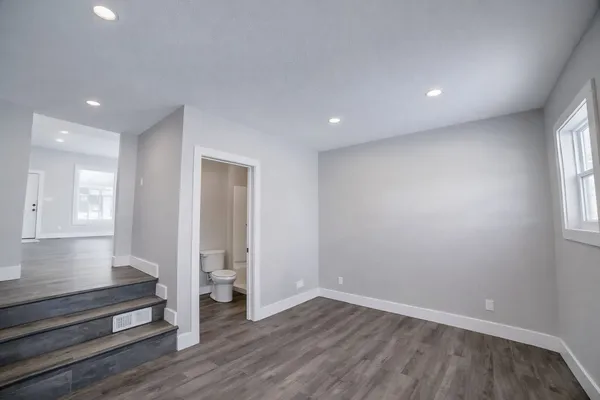 wooden floor in an empty room with a window