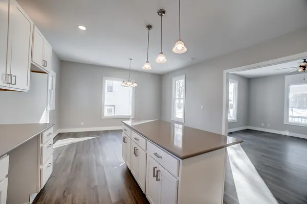 a kitchen with a sink window and cabinets