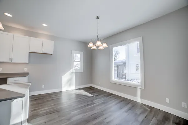 a large kitchen with chandelier in it