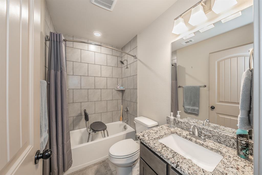 2376 Farm To Market Road 2264 Decatur, TX 76234 - Photo 14 of 39 a bathroom with a granite countertop sink toilet a mirror and shower