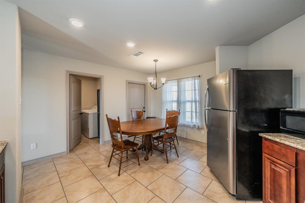 2376 Farm To Market Road 2264 Decatur, TX 76234 - Photo 23 of 39 a kitchen with a refrigerator a table and chairs