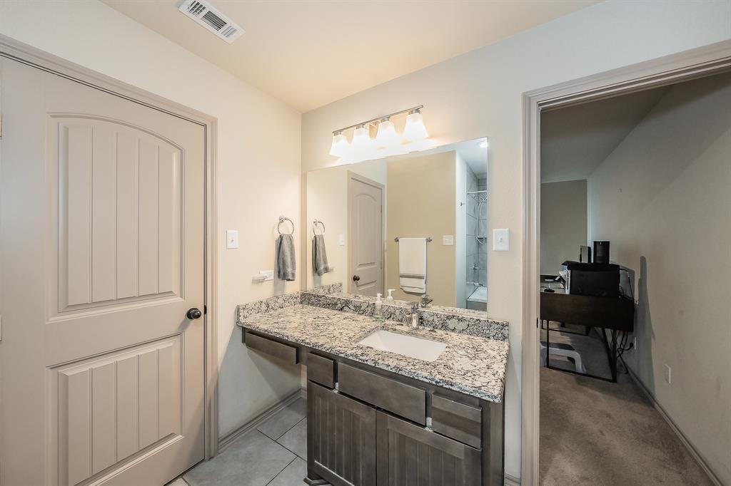 2376 Farm To Market Road 2264 Decatur, TX 76234 - Photo 32 of 39 a bathroom with a granite countertop sink a toilet and a mirror